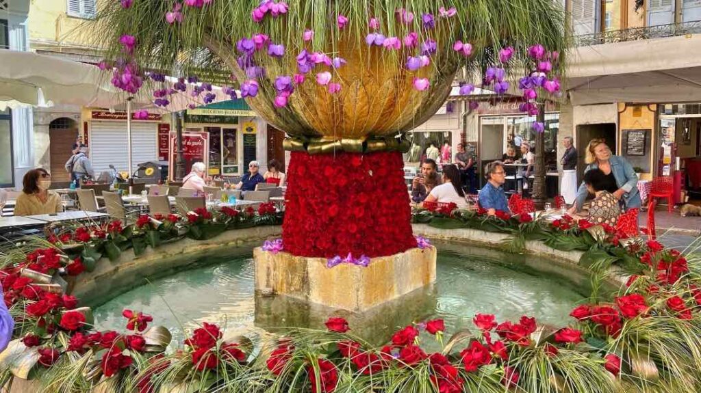 The fountain at Place aux Aires is beautifully decorated with colorful roses